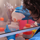 A scientists in a blue lab coat is making